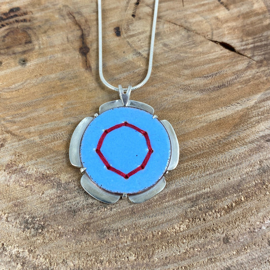 Blue Circle Pendant with Silver and Red Stitches